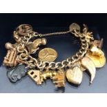 9ct Gold charm bracelet with approx 22 charms, all gold charms are 9ct or above and includes an 18ct