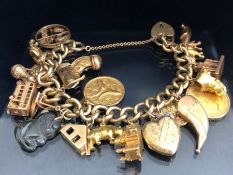 9ct Gold charm bracelet with approx 22 charms, all gold charms are 9ct or above and includes an 18ct