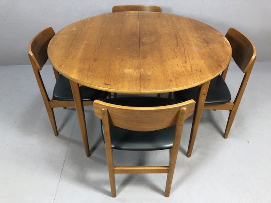 Mid century teak extending dining table by Nathan accompanied by four teak dining chairs with