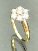 18ct hallmarked Gold & Platinum diamond daisy cluster ring comprising seven claw set brilliant cut