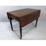 Pembroke drop leaf table on turned legs and brass castors