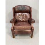 Red leather reclining club style armchair, with studded detail