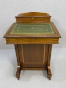 Davenport desk by Maple & Co with green leather writing slope, on castors, with key. Approx 53cm x