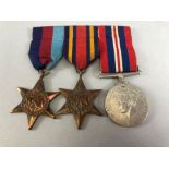 Medals: 1939 -45 Star, Burma Star and war medal with ribbons on bar