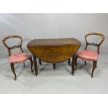 Antique drop leaf extending dining table on turned reeded legs with castors accompanied by two