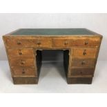 Harvey Nichols 1930s oak twin pedestal kneehole desk with eight drawers and green leather top,