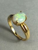 18ct Gold ring set with a cushion cut Opal approx 7mm x 9mm in a four claw setting size approx 'N' &