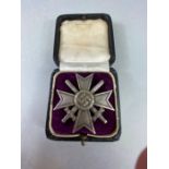 Militaria: Boxed WWII German merit Cross with swords stamped "20" to the reverse pin A/F