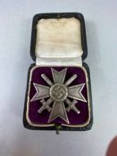 Militaria: Boxed WWII German merit Cross with swords stamped "20" to the reverse pin A/F
