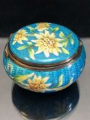 Pill box decorated in enamel and depicting Edelweiss, with hinged lid and lined in 9ct gold and