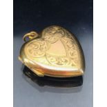 9ct Gold (back and front) heart shaped locket hinged to the side approx 21mm x 23mm