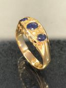 18ct gold three stone sapphire and diamond ring on raised and pierced setting approx size 'O' and