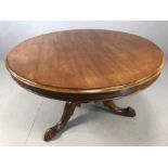 Circular mahogany pedestal table on tripod heavily carved feet approx 1 metre in diameter
