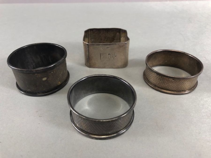 Collection of four silver hallmarked napkin rings total weight approx 55.5g