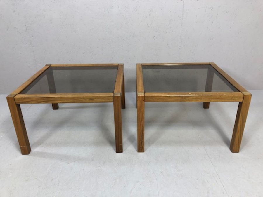Pair of Mid Century style wooden framed coffee tables with smoky glass tops, each approx 56cm x 56cm