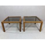 Pair of Mid Century style wooden framed coffee tables with smoky glass tops, each approx 56cm x 56cm