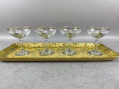 Four good Babycham glasses on a papier mache rectangular tray decorated with flowers