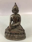 Bronze Buddha or eastern Deity seated with hand touching the ground, approx 13cm tall and hollow