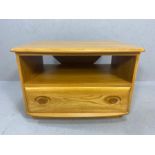 Blond Ercol TV table with corner drop leaf to reverse and shelf and cupboard under, approx 73cm x