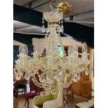 Glass eight arm chandelier with brass fittings and beaded drops, along with four matching wall