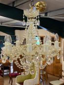 Glass eight arm chandelier with brass fittings and beaded drops, along with four matching wall