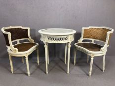 Louis-style white painted circular table with two cane backed and seated low chairs, table approx