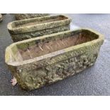 Pair of oblong garden troughs / planters with lions head detailing, each approx 71cm x 28cm x 26cm