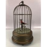 Victorian 20th Century bird cage automaton, with a clockwork mechanism operating red feathered