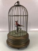 Victorian 20th Century bird cage automaton, with a clockwork mechanism operating red feathered