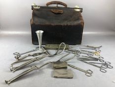 An Edwardian Leather Doctors or Gladstone Bag containing some vintage doctors medical equipment with