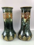 A pair of Royal Doulton vases of bulbous form with grape and vine decoration, impressed number