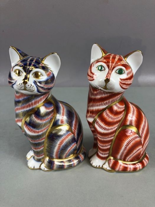 Two Royal Crown Derby paperweights in the form of seated cats, each approx 13cm in height