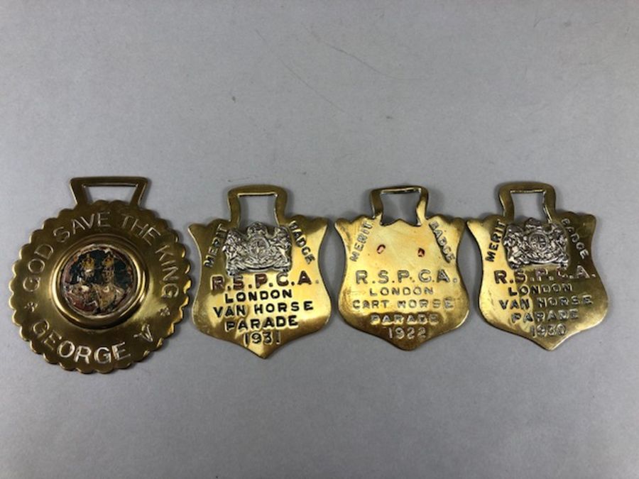 Collection of four vintage Horse brasses to include three RSPCA brasses and a George V, "GOD SAVE