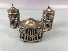 Victorian Silver Hallmarked cruet set with blue glass liners hallmarked for London 1895 and maker