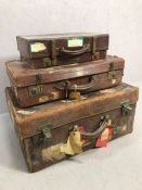 Collection of three vintage leather suitcases and briefcase with various labels attached including