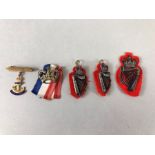 Collection of military cap badges to include gold coloured Royal Navy pin with blue enamel (5)