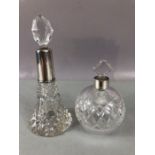 Two Silver topped and hallmarked cut glass scent bottles each with stoppers, the tallest approx 17cm