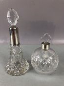 Two Silver topped and hallmarked cut glass scent bottles each with stoppers, the tallest approx 17cm