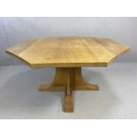 Workshop of Robert Mouseman Thompson: An English oak octagonal dining table, on a cruciform base,