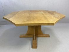 Workshop of Robert Mouseman Thompson: An English oak octagonal dining table, on a cruciform base,