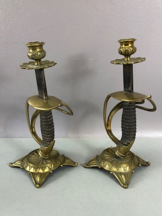 Pair of candlesticks fashioned from cavalry sword handles, decorated brass cast bases and