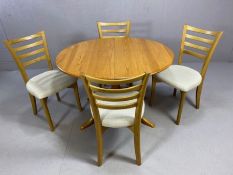 Modern Ercol Elm Chester oval dining table, extendable with one leaf on four legs with 4 matching