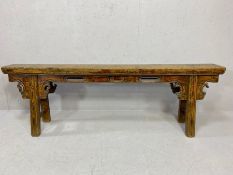 Chinese Antique elm bench, the single plank top with foliate carved supports on splayed legs with