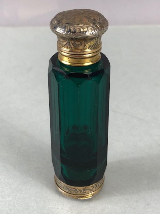 Victorian double ended scent and vinaigrette bottle in green glass with two hinged lids