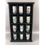 Open Display wall unit with 12 Japanese Brush pots of various floral designs