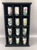 Open Display wall unit with 12 Japanese Brush pots of various floral designs