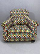 Newly re-upholstered armchair, in harlequin design, with front castors, approx 83cm in height (at