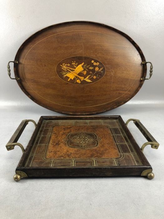 Two tea trays, one Edwardian Oval with inlay and the other a square twin handled tray with brass