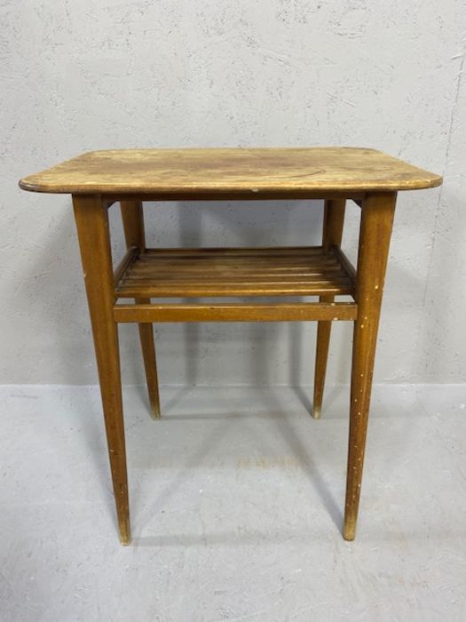 Mid century style side table with slated shelf and tapering legs