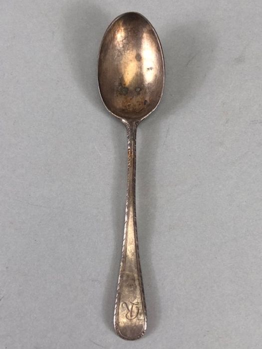 Three silver hallamrked items to include sugar nips a miniature cream jug and a spoon - Image 10 of 12